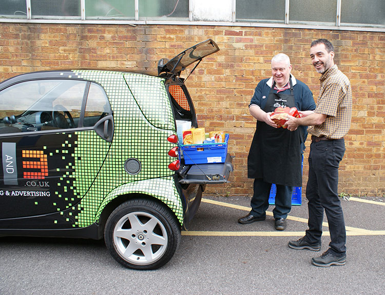Simon Dawson giving food to the foodbank